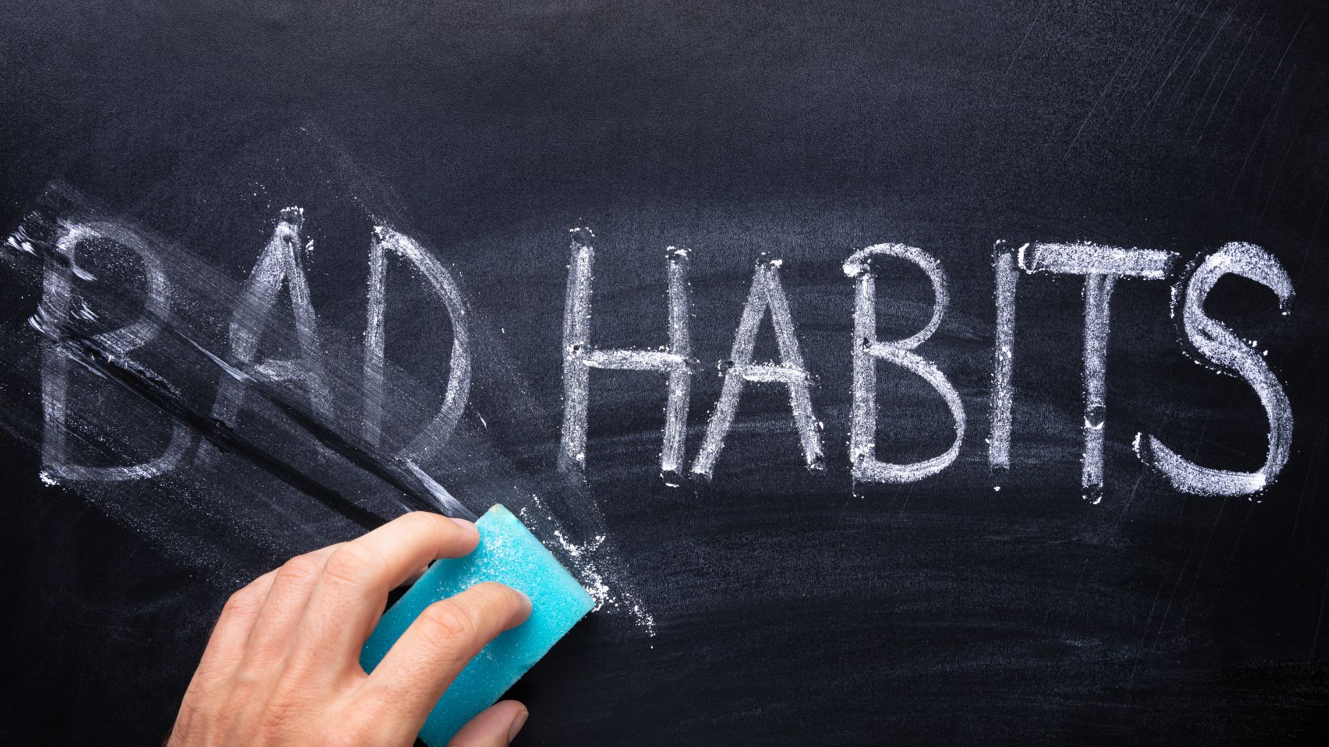 The words Bad Habits being erased from a chalkboard.