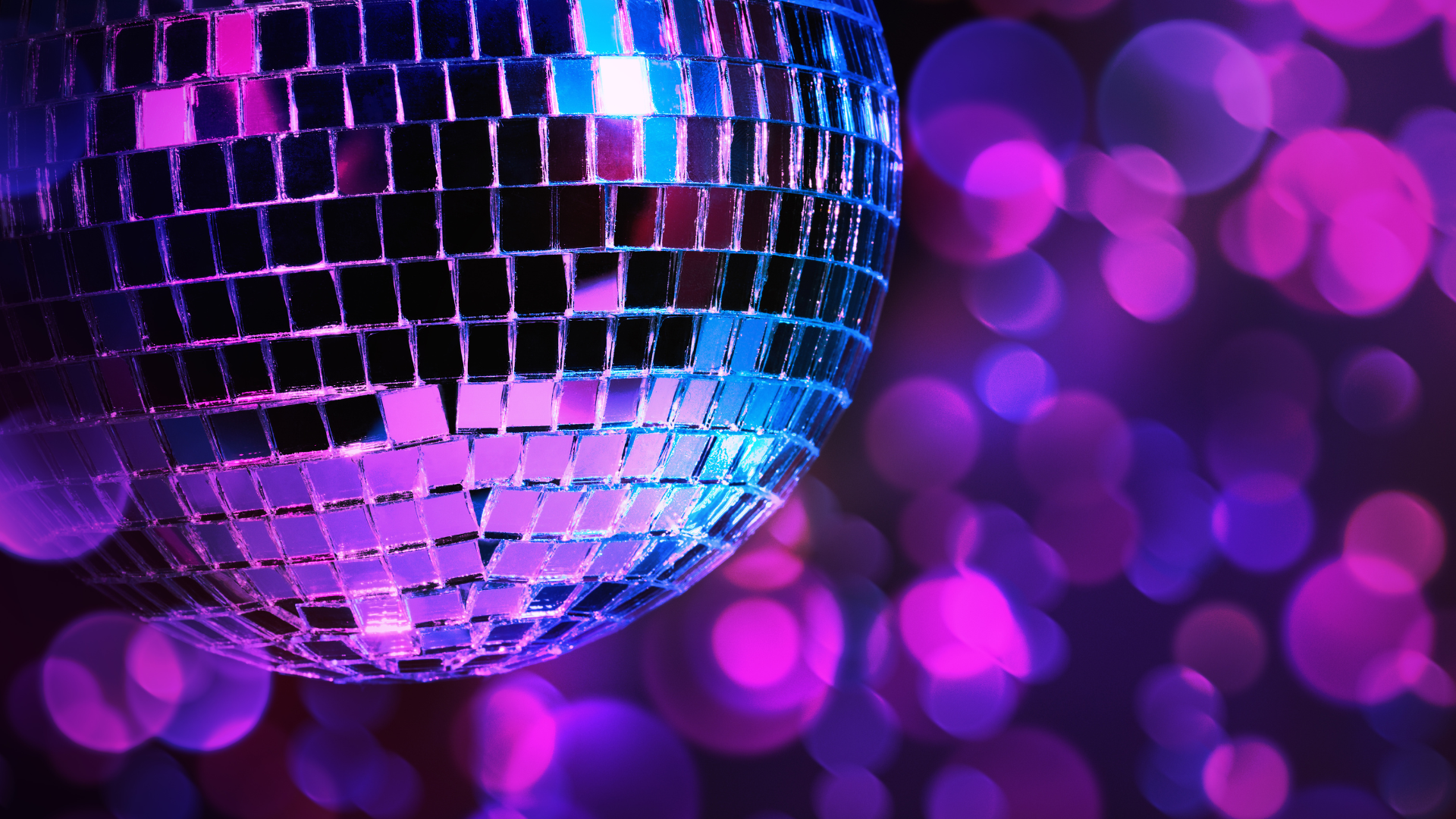 A disco ball glittering against a purple background.