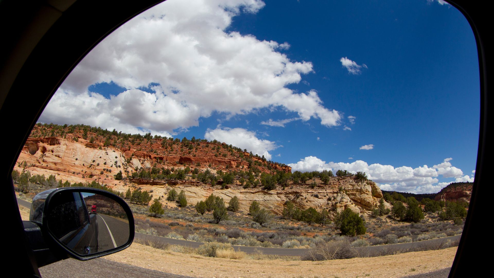A view of the mountains as seen through a car window.