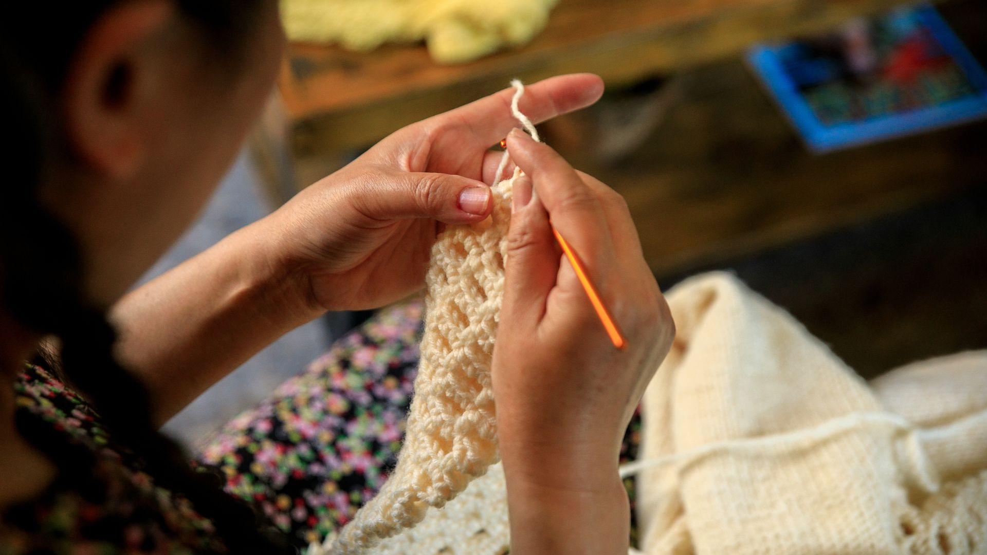 A woman working on a crochet project.